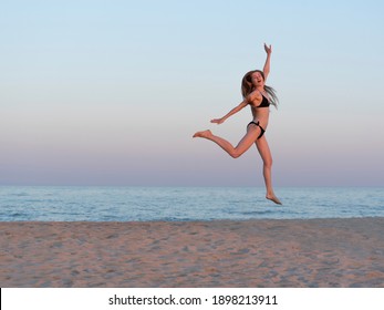 Girl jumping by the sea