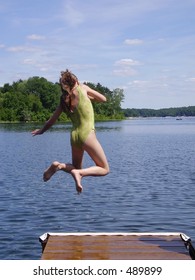 Girl Jumping From Dock At A Connecticut Lake