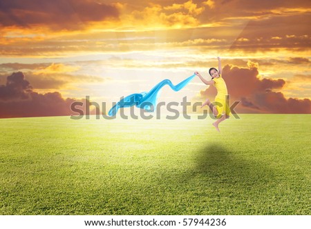 Girl jumping on meadow before sunset