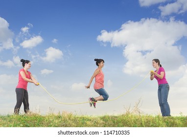 Girl jumping over a rope
