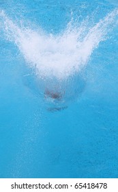 A Girl Jumps From A Diving Platform Into The Pool