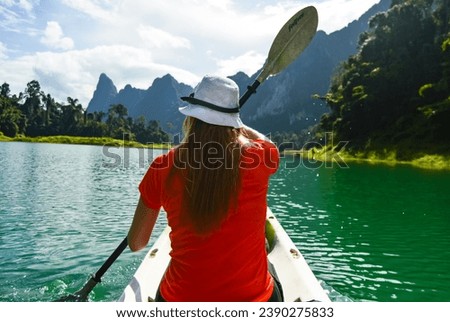 A Girl Kayaking on Cheow Lan Lake, Khao Sok National Park, Surat Thani, Thailand