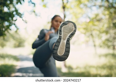Girl kicking with her leg in camera, sole close up. Foreground focus