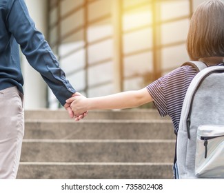 Girl Kid (elementary Student) Carrying Backpacks Holding Parent Mother's Hand Walking Up Educational Building's Stair Going To Class For Back To School First Day And Bring Kid To Work Concept