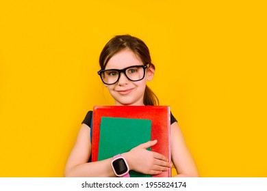 Girl Kid Glasses With Smartwatch Looking At Camera In Isolation On A Yellow Background. Back To School.