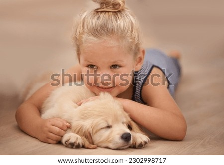 Girl kid hug her puppy, relax at home and happy with sleeping golden retriever dog and child with smile. Happiness, pet care and love with young female and her domestic animal lying on wood floor