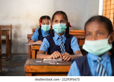 Girl Kid With Medical Face Mask Listening Class At School While Maintaining Social Distance - Concept Of Coronavirus Covid-19 Protection, Pollution Prevention And Back To School