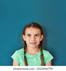 Girl, kid and smile with thinking on mockup with question, imagination and curiosity on blue background. Person, uncertain child and thoughtful with wondering, daydreaming and contemplating on space - Powered by Shutterstock