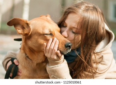 Girl Kissing Hugging Dog Pet Cute Adorable Red Dog Friendly Closeup Closing Eyes Funny Animals