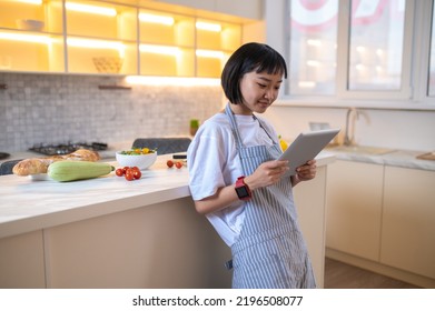 A Girl In The Kitchen Reading A Cookery Blog Online