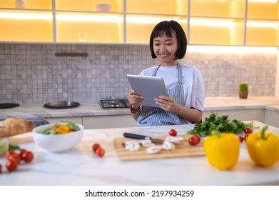 A Girl In The Kitchen Reading A Cookery Blog Online