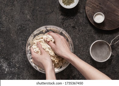 Girl Kneads Dough For Baking Homemade Bread On A Black Stone Table. Cooking At Home Ourselves