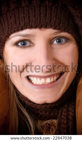 The Girl in a knitted cap smiles