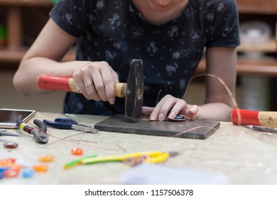 Girl knocks with a hammer - Shutterstock ID 1157506378