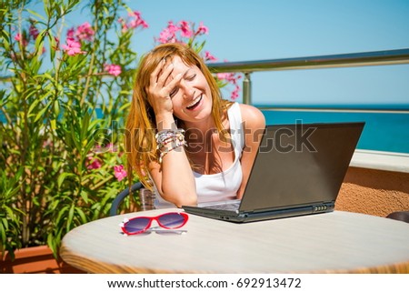 girl with a laptop. Beautiful smiling woman working on laptop on the terrace summer cafe. blogger journalist web internet. Work online, Correspondence on the Internet, chat dating
