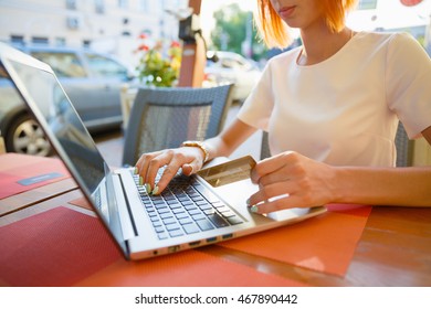 Girl With A Laptop In A Cafe, Shop With A Credit Card.