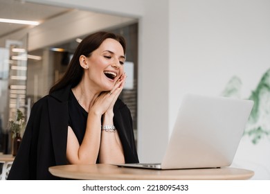 Girl With Laptop Smile, Laughs And Discussing Funny Situations At Work With Colleagues. Video Meeting With Friends And Colleagues And Have Fun Online Remotely After Successful Project