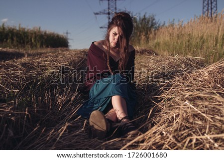 girl laughing in a field at sunset