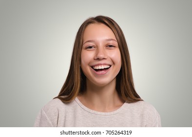 The girl laughs. Attractive young girl portrait. Beautiful  female looking at camera. Healthy woman studio portrait. 