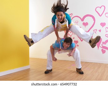 Girl Leap Frogs Over Man.