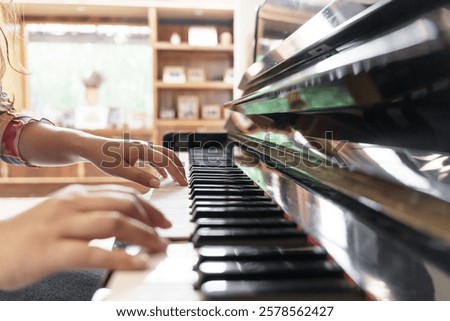 Girl learn to play piano. woman hand playing piano 
