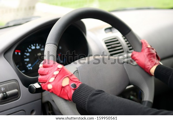 Girl in leather gloves is\
driving 