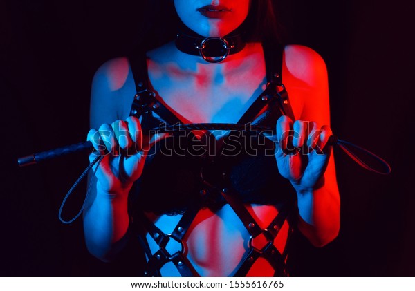 革製の馬具を着た女の子は smの性行為に向けて フロガーの鞭を手に持つ の写真素材 今すぐ編集
