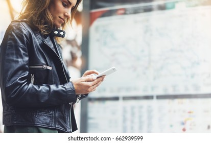 Girl in leather jacket holding smart phone on background map light box in sun city, hipster using in female hands and text mobile, glitter street lifestyle, tourist planing route in summer concept - Powered by Shutterstock