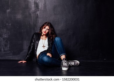 Girl In Leather Jacket Pitchman Style On A Black Background