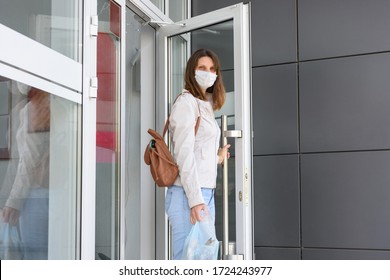 A Girl Leaving The Store In Casual Clothes And A Medical Mask