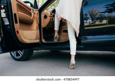 Get into car. Girl Legs into car. The girl weighs 120 kg and tries to get into the car.