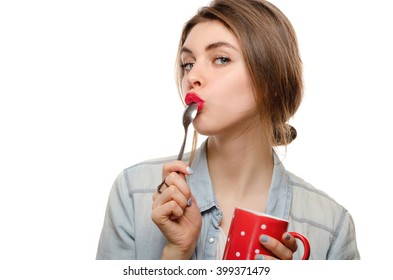 Girl Lick Spoon From Tea On White Background