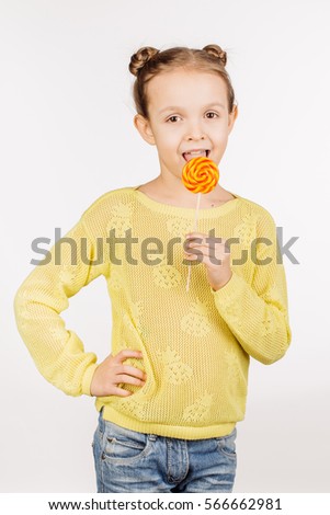 girl licking round lollypop