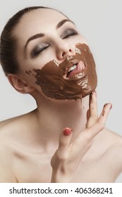 The Girl Licking The Smeared Chocolate From Lips