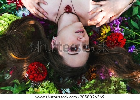 Similar – a girl with blue eyes and long hair with a beard of gerbera flowers