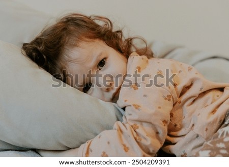 Similar – Little girl smiling lying over the bed