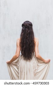 Girl With Long Black Hair In A Gentle Silk Wedding Dress