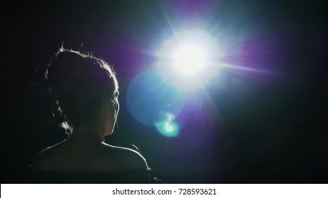 Girl in long gown performing on stage. the girl singing on the stage in front of the spotlight. Silhouette of singer standing on stage at microphone in night club - Shutterstock ID 728593621
