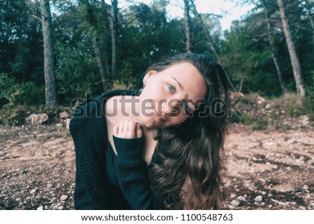 Similar – ein Mädchen mit langen Haaren und blauen Augen in den Bergen, das mit einer Kapuze lächelt