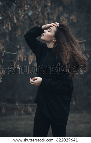 Similar – a girl with long hair and blue eyes in the mountain covering her face with her hair