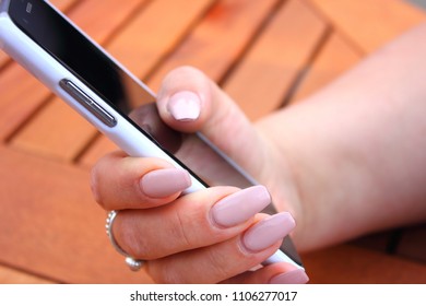 Girl With Long Nails Holding A Mobile Phone