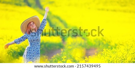 Girl in a long vintage dress hat in a field of flowers, happy summer sunny freedom female