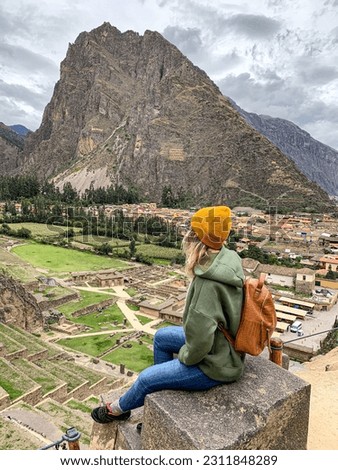 Girl look on the Beautiful view of the ruins of Ollantaytambo Inca archaeological site in southern Peru near Cusco. The royal estate of Emperor Located in the Sacred Valley of the Incas. Tourism Peru