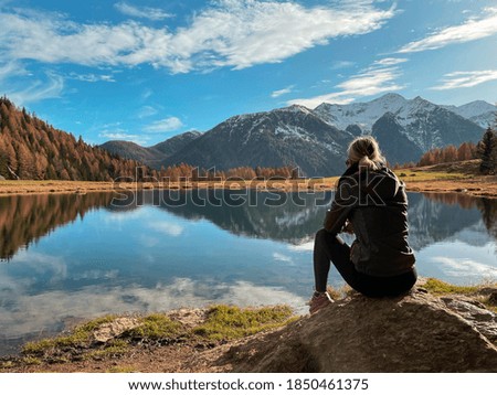 
girl looking at the autumn landscape in the mountains during a hike