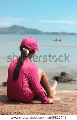 Girl looking at Beautiful beach in Brazilian summer