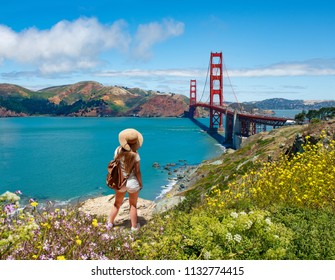 Girl looking at beautiful summer coastal landscape, on hiking trip. Woman relaxing on mountain. Golden Gate Bridge, over Pacific Ocean and San Francisco Bay, San Francisco, California, USA. - Powered by Shutterstock