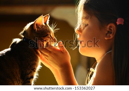 girl looking at the cat
