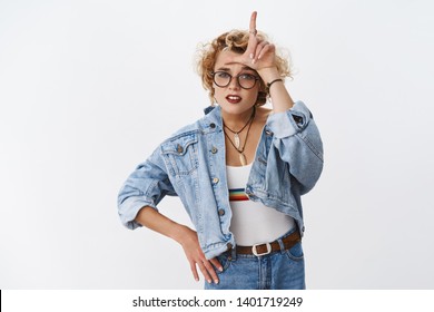 Girl Looking With Dismay At Losers. Portrait Of Arrogant And Confident Good-looking Stylish Woman With Short Blond Haircut Mocking Rival Showing L Letter On Forehead And Grimacing Like Snob