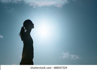 Girl looking into the sky thinking. 