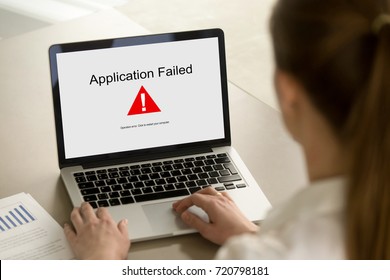 Girl Looking At Laptop With Application Failed Error On Screen. App Stopped Working, Software Failure, Computer Unit Broke, System Crashed Unexpectedly, Malware Concept. Close Up, Focus On Screen.